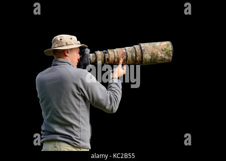 Professional Wildlife Photographer isolati su sfondo nero Foto Stock