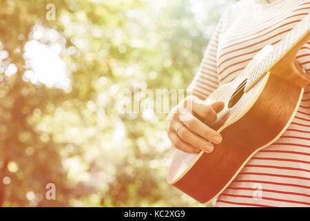 Anonimo donna giocando ukulele Foto Stock