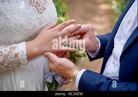 Lo sposo abiti sposa anello sul suo dito Foto Stock