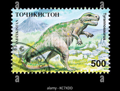 Francobollo dal Tagikistan raffigurante un tirannosauro. Foto Stock