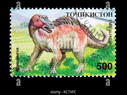 Francobollo dal Tagikistan raffigurante un Anatosaurus Foto Stock