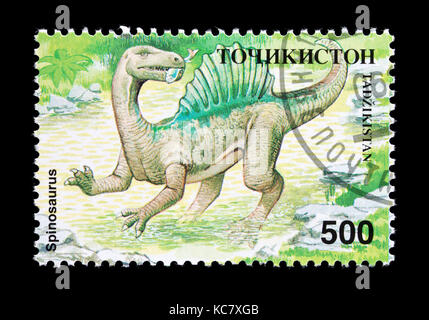 Francobollo dal Tagikistan raffigurante un Spinosaurus. Foto Stock