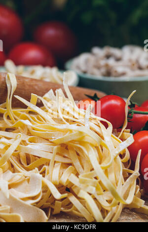 Close-up di impreparati pasta italiana con pomodori freschi Foto Stock