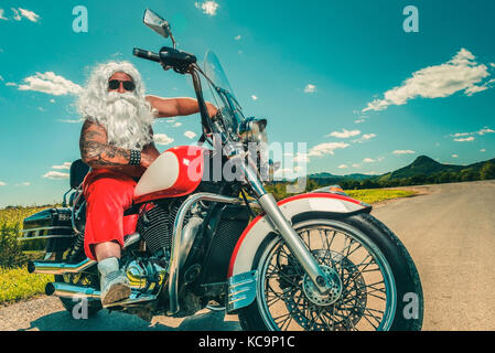 Santa su una motocicletta Foto Stock