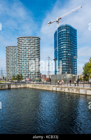 Torre della pompa, una nuova build blocco di appartamenti in fase di costruzione in Royal Victoria Dock, vicino a due altri blocchi completato, a Londra E16, Inghilterra, Regno Unito. Foto Stock