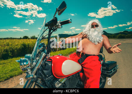 Santa su una motocicletta Foto Stock