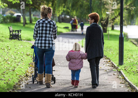 Una nonna, una figlia e una nipote che si godono una passeggiata al sole. Foto Stock