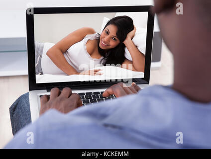Close-up di persona avente la Video Chat con la donna su Laptop Foto Stock
