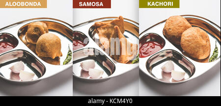 Samosa , kachori e alubonda o batata vada - indian fritte junk ma gustoso cibo o spuntini serviti in lamiera di acciaio inox su sfondo bianco w Foto Stock