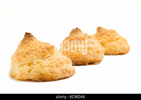 Deliziosa spagnolo meringa cocco cookies (amaretti di noce di cocco o di uva sultanina de coco) su sfondo bianco Foto Stock