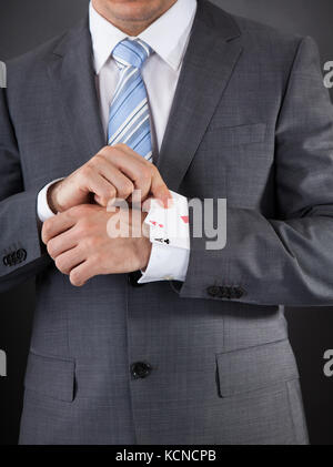 Close-up di commercianti nascondendo Poker Card nel manicotto Foto Stock