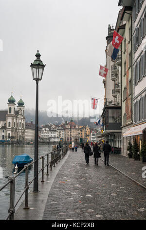 Lucerna, Svizzera - febbraio 04, 2010: lucerna in inverno di nebbia, pioggia e maltempo. la gente camminare sul lungomare nel centro della citta'. Foto Stock