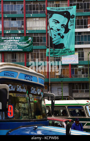 La Paz, Bolivia. 6th Ott 2017. Un banner per commemorare il 50th° anniversario della morte di che Guevara è appeso all'edificio della facoltà di Ingegneria dell'Università UMSA nel centro di la Paz. Che è stato ucciso dalle truppe boliviane a la Higuera il 9th ottobre 1967; il governo e i movimenti sociali terrà diversi eventi in quella data presso il luogo. Nel rinuncio è uno dei tipici micro bus della città. Credit: James Brunker/Alamy Live News Foto Stock