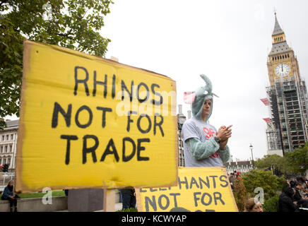 Centinaia di attivisti di Action for Elephants UK organizzano una protesta silenziosa a Parliament Square, Londra, per sensibilizzare la popolazione alla crisi bracconda che spinge rinoceronti ed elefanti all'estinzione e per esortare il governo ad attuare un divieto sul commercio di avorio nel Regno Unito. Foto Stock