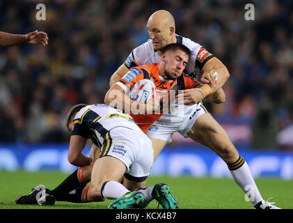 La Castreford Tigers' Greg Minikin viene affrontata dai giocatori di Leeds Rhinos durante la finalissima Betfred Super League a Old Trafford, Manchester. Foto Stock