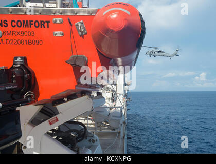 171006-N-MU198-223 MAR DEI CARAIBI (ott. 6, 2017) un MH-60S Seahawk, attaccato al 'Sea Cavalieri' di elicottero di mare squadrone di combattimento (HSC) 22 ritorna alla nave ospedale USNS Comfort (T-AH 20) durante una evacuazione medica. Il comfort è arrivato in Arecibo- Manati regione di Puerto Rico per fornire servizi medici con visite aggiuntive essendo previsto intorno l'isola. Gli Stati Uniti La salute e i servizi umani e Puerto Rico Dipartimento di Salute rappresentanti stanno dando priorità ai pazienti a ogni fermata prima di comfort dell'arrivo. Il Dipartimento della difesa è di sostenere la Federal Emergency Management Agen Foto Stock