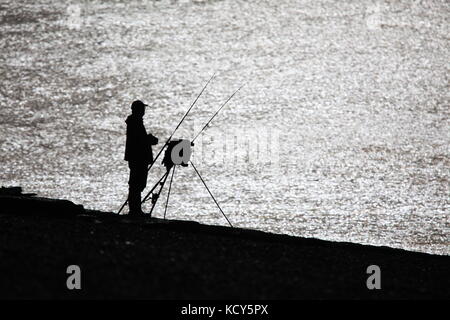 Hastings, East Sussex, Regno Unito. 8 ottobre 2017. Delineare la silhouette di un pescatore sulla spiaggia. Photo credit: Paolo Lawrenson /Alamy Live News Foto Stock