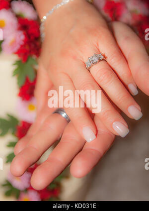 Primo piano della sposa giovane con le mani in mano dotato di anelli di nozze. Soft focus. Foto Stock