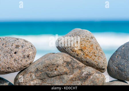 Spiaggia di ciottoli formando una parete con la spiaggia in background, Playa piedras caidas, Fuerteventura, Isole Canarie, Spagna Foto Stock