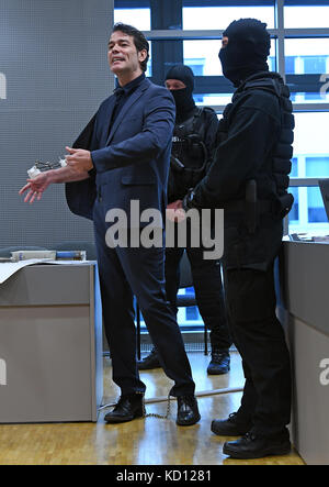 Halle/Saale, Germania, 09 ottobre 2017. L'ex "Mister Germany", Adrian Ursache (L), ha parlato con i giornalisti prima dell'inizio del suo processo in una sala del tribunale distrettuale di Halle/Saale, Germania, il 9 ottobre 2017. Il 42enne Ursache deve difendersi davanti al tribunale distrettuale contro le accuse di tentato omicidio quasi 14 mesi dopo una sparatoria con un commando speciale durante uno sfratto forzato. Ursache stesso fu gravemente ferito durante lo scambio di incendi. Credito: dpa Picture Alliance/Alamy Live News Foto Stock