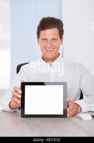 Portrait Of A Businessman Showing Blank Digital Tablet Foto Stock