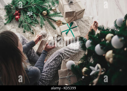 Donna decorazione di un regalo di natale Foto Stock