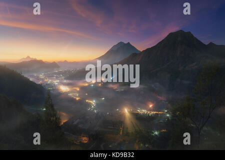 Villaggio pinggan nebbia all alba con vulcani all'orizzonte, batur Foto Stock