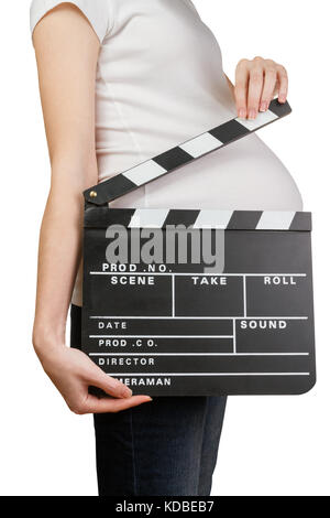 Donna incinta holding clapperboard Foto Stock