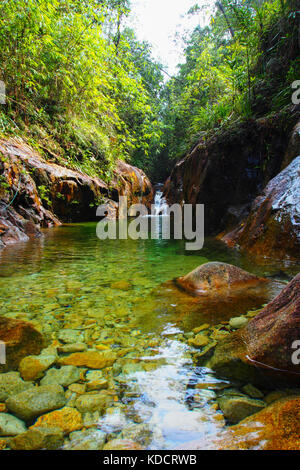 Crystal clear stagno con una piccola cascata nella foresta pluviale tropicale, chemerong berembun langsir, cbl malaysia Foto Stock