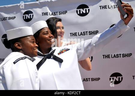 I marinai statunitensi scattano una foto selfie con l'attrice Bridget Regan sul tappeto rosso durante la prima stagione della serie TV TNT The Last Ship al Naval base San Diego Theater il 23 luglio 2017 a San Diego, California. (Foto di Indra Bosko via Planetpix) Foto Stock