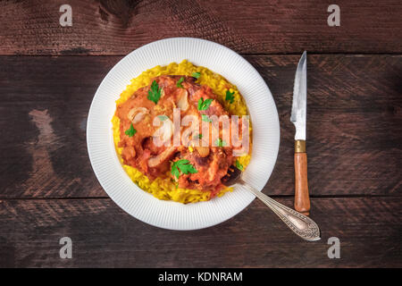 Osso Buco con risotto alla milanese e gremolata Foto Stock