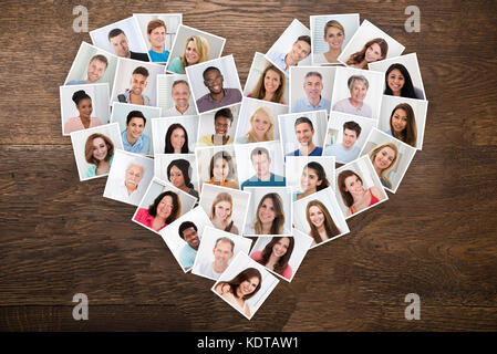 Foto di popolo sorridente con diverse società multietnica in una forma di cuore Foto Stock