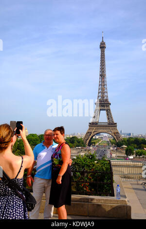 Una coppia matura hanno le loro foto scattata su uno smartphone di fronte alla Torre Eiffel a Parigi Foto Stock