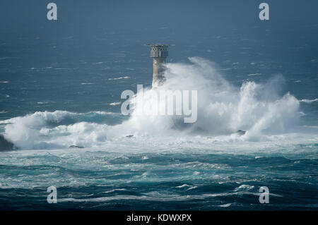 Le onde si infrangono sul faro di longships al largo della costa di Lands End, Cornovaglia, mentre l'uragano Ophelia colpisce il Regno Unito e l'Irlanda con raffiche fino a 80 mph. Foto Stock