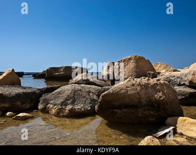 Caduta massi di pietra calcarea e le rocce vicino alla costa di Gozo a Malta Foto Stock