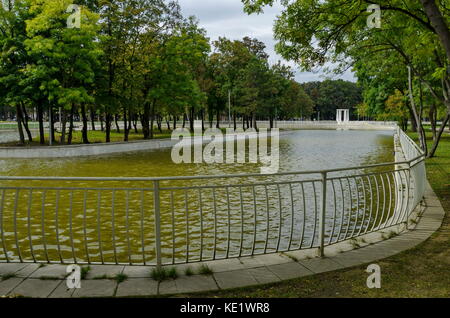 Popolare il parco nord per il resto con autunnale di vecchia foresta panca in legno e il lago nel quartiere vrabnitsa, sofia, Bulgaria Foto Stock