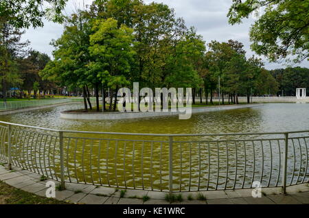 Popolare il parco nord per il resto con autunnale di vecchia foresta panca in legno e il lago nel quartiere vrabnitsa, sofia, Bulgaria Foto Stock