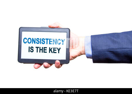 Imprenditore mano azienda tablet con coerenza è il testo chiave segno. isolato su bianco. Concetto aziendale. stock photo Foto Stock