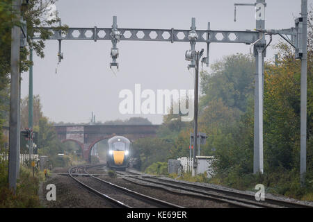 Un nuovo elettro-diesel di classe 800 passa attraverso la parte non elettrificata della linea ferroviaria principale del Great Western in direzione ovest verso il ponte di grado II sulla B4017 a Steventon, Oxfordshire, che impedisce la piena elettrificazione della linea ferroviaria principale del Great Western, poiché è troppo bassa. Foto Stock