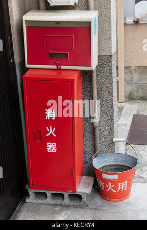 Kyoto, Giappone - 23 maggio 2017: tradizionale rosso fuoco secchio con acqua nella parte anteriore della casa come la prevenzione degli incendi in kyoto Foto Stock