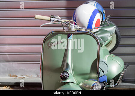 Cassano Magnago, Italia - 8 ottobre 2017: Vespa verde con casco appoggiato sulla sella Foto Stock