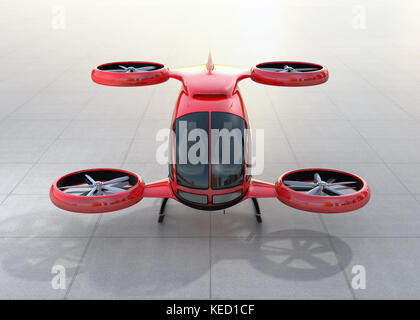 Vista frontale del rosso metallizzato auto-guida drone passeggero sbarco sulla terra. Il rendering 3d'immagine. Foto Stock
