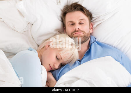 Close-up della giovane coppia felice dormire insieme nel letto di casa Foto Stock