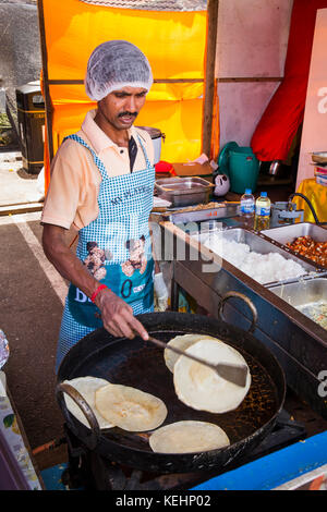 La Seychelles, Mahe, Victoria, India giorno, cibo indiano stallo, chef cucinare puri in Karahi Foto Stock