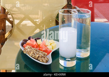 Bicchiere di ouzo e meze piastra su una tabella in Grecia Foto Stock