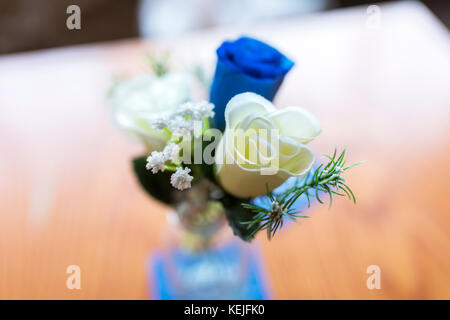 Close up del bianco e del blu rose come una decorazione della tavola in un vasetto di vetro in un tradizionale matrimonio in inglese Foto Stock