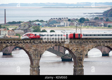 La Vergine Azuma treno attraversa Royal ponte di frontiera a Berwick upon Tweed in viaggio verso nord sul suo primo viaggio in Scozia. Foto Stock