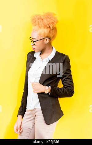 Ritratto di un africano business lady su sfondo giallo Foto Stock