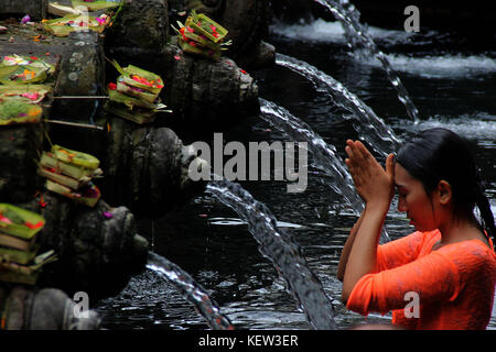 Bali, Indonesia. 23 Ott, 2017. pura Tirta Empul, Tampak Siring bali-ummah hindu bali pregando nel tempio santo di Tirta Empul, tampaksiring gianyar regency bali indonesia lunedì 23 ottobre, 2017. Nel tempio vi è una primavera sacra ritenuti efficaci per l'auto-pulizia così come una cura per tutte le malattie . Ogni giorno molti indù e turisti provenienti da diversi paesi utilizzano la Primavera sacra. Foto Stock