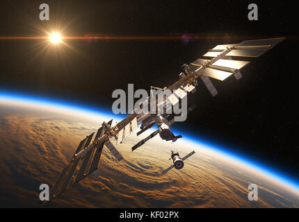 La stazione spaziale internazionale e veicoli spaziali in background di Rising Sun Foto Stock